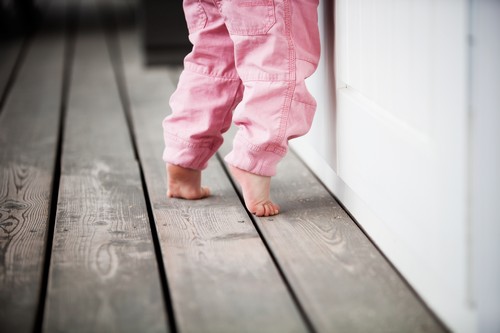 Little girl walking on tip toes